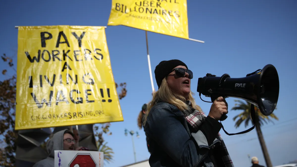 People holding signs and a bullhorn.