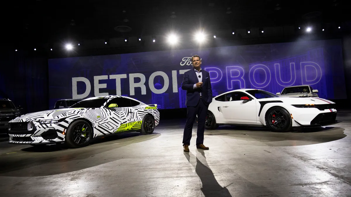 Ford CEO Jim Farley standing between two Ford models in Detroit, Michigan on Jan. 9, 2025