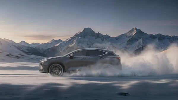 A Lexus vehicle kicks up snow driving across an icy landscape in a holiday video from the automaker