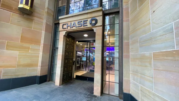 A doorway tucked back from the street is shown within a stone building and the "Chase" logo and name above the entrance.