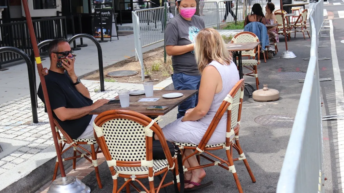 A masked employee at Pearl Dive Oyster Palace in Washington, D.C. on July 10, 2020.