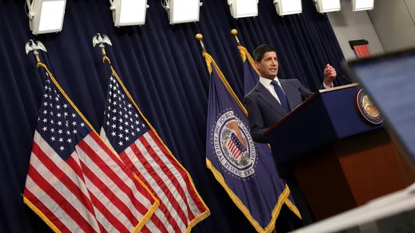 Federal Reserve Chair Kevin Warsh stands at the podium speaking during a news conference