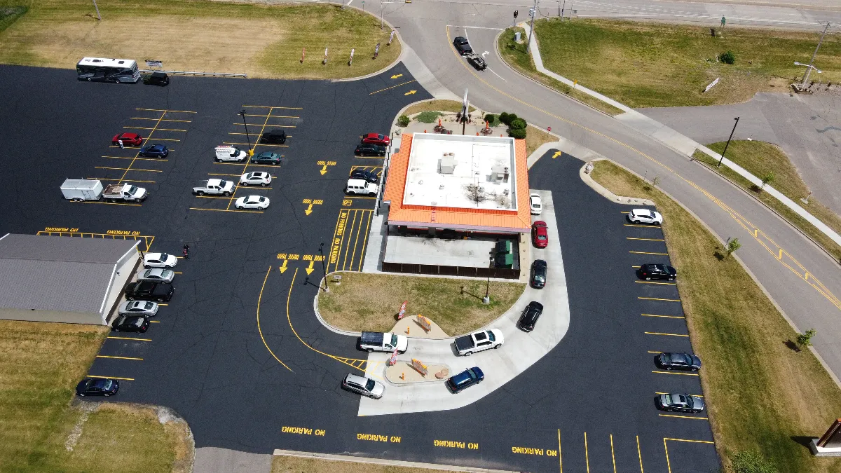 An aerial image of an A&W double drive-thru restaurant