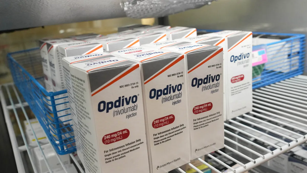 Pharmaceutical cartons with the logo for Bristol Myers Squibb's Opdivo rest on a refrigerator shelf.