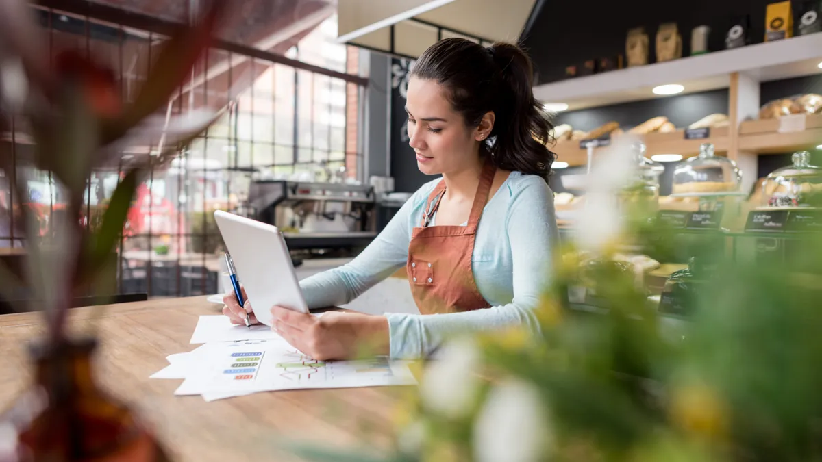 Woman doing books at a restaurant