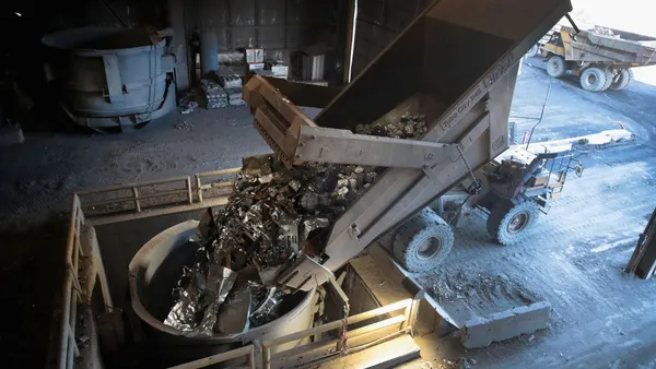 Scrap steel seen being loaded into a bucket.