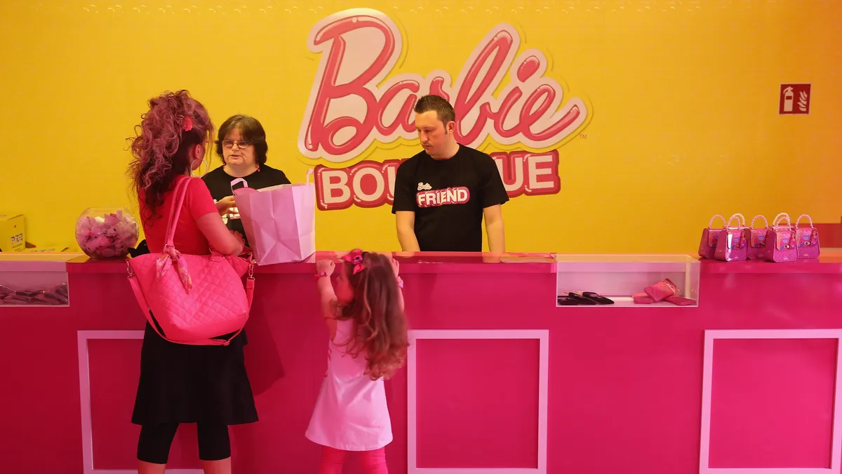 People purchase souvenirs at the Barbie Dreamhouse Experience on May 16, 2013 in Berlin, Germany.