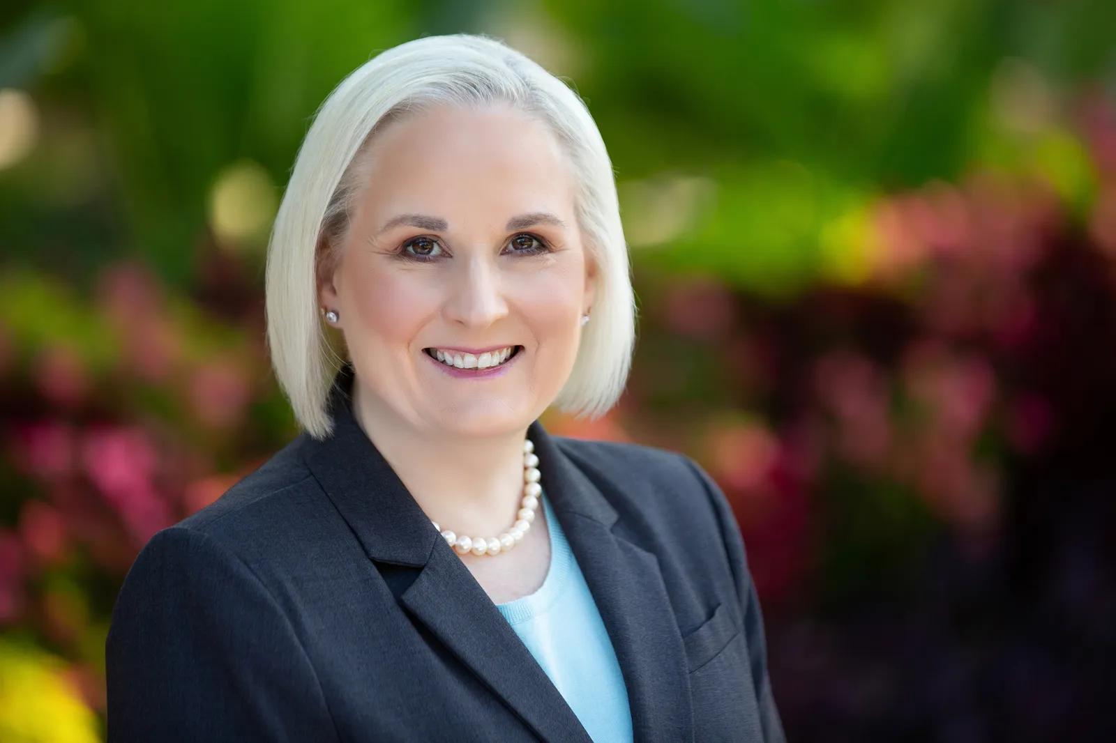 Headshot of a person in a suit.