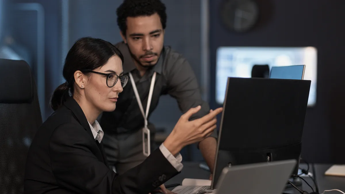 Computer engineers review information on a screen