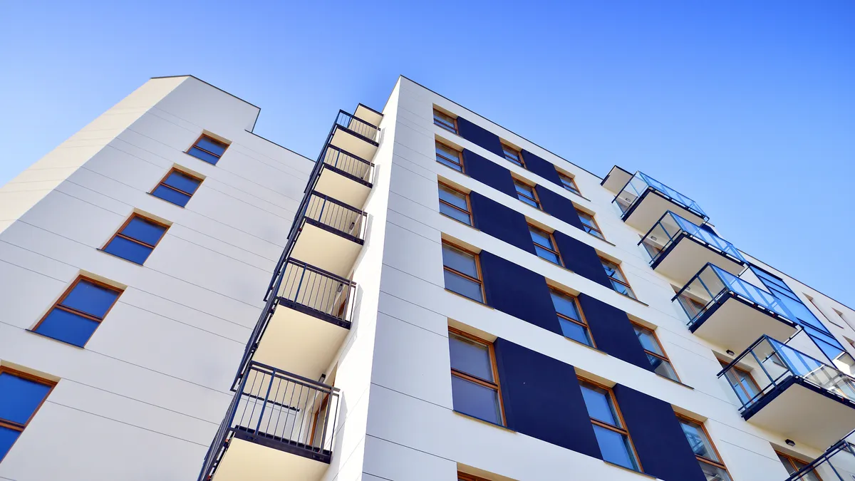 a high-rise apartment building seen from the ground up