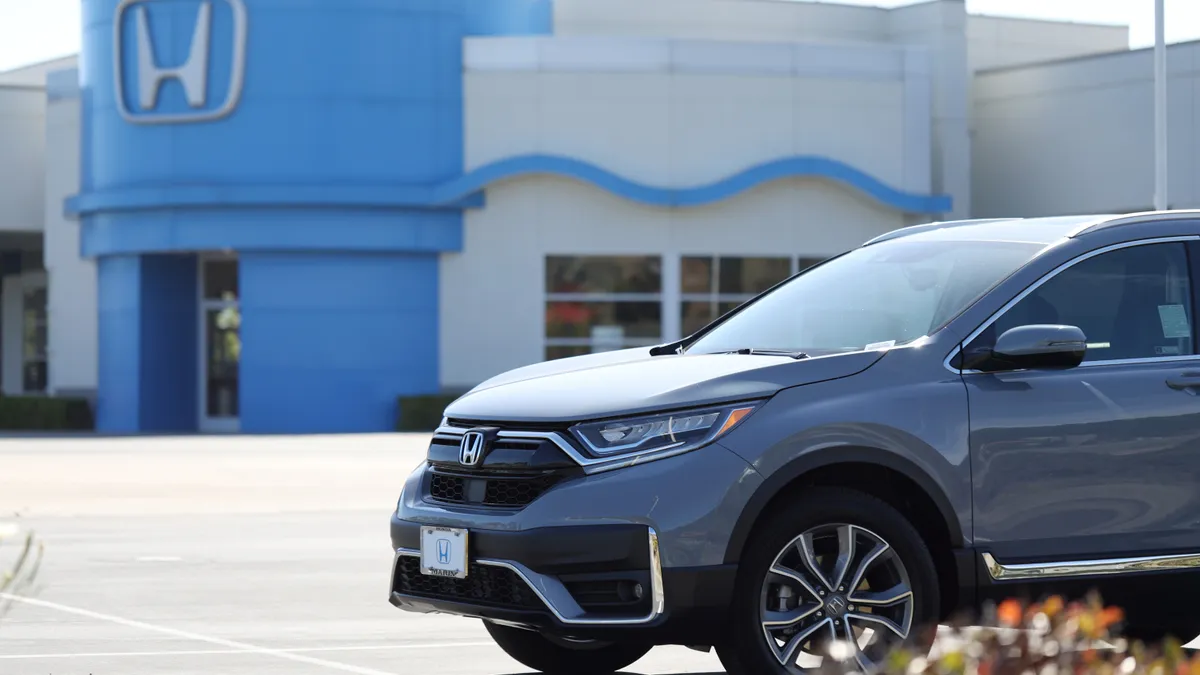 A blue Honda vehicle sits on the sales lot at a Honda dealership in California.