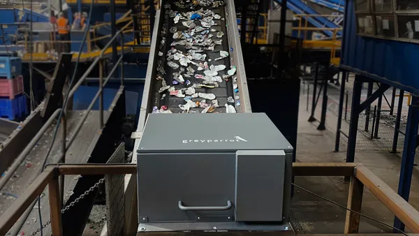 A Greyparrot AI system sits on top of a sorting line