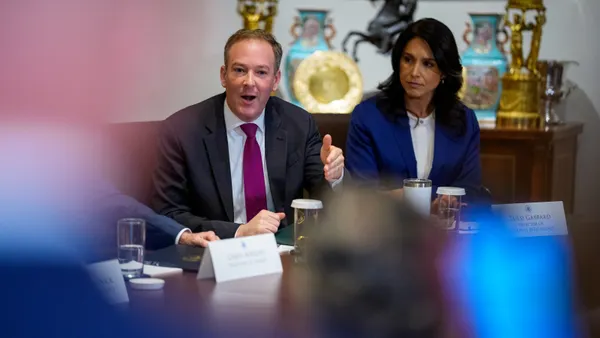 A man speaks next to a woman.