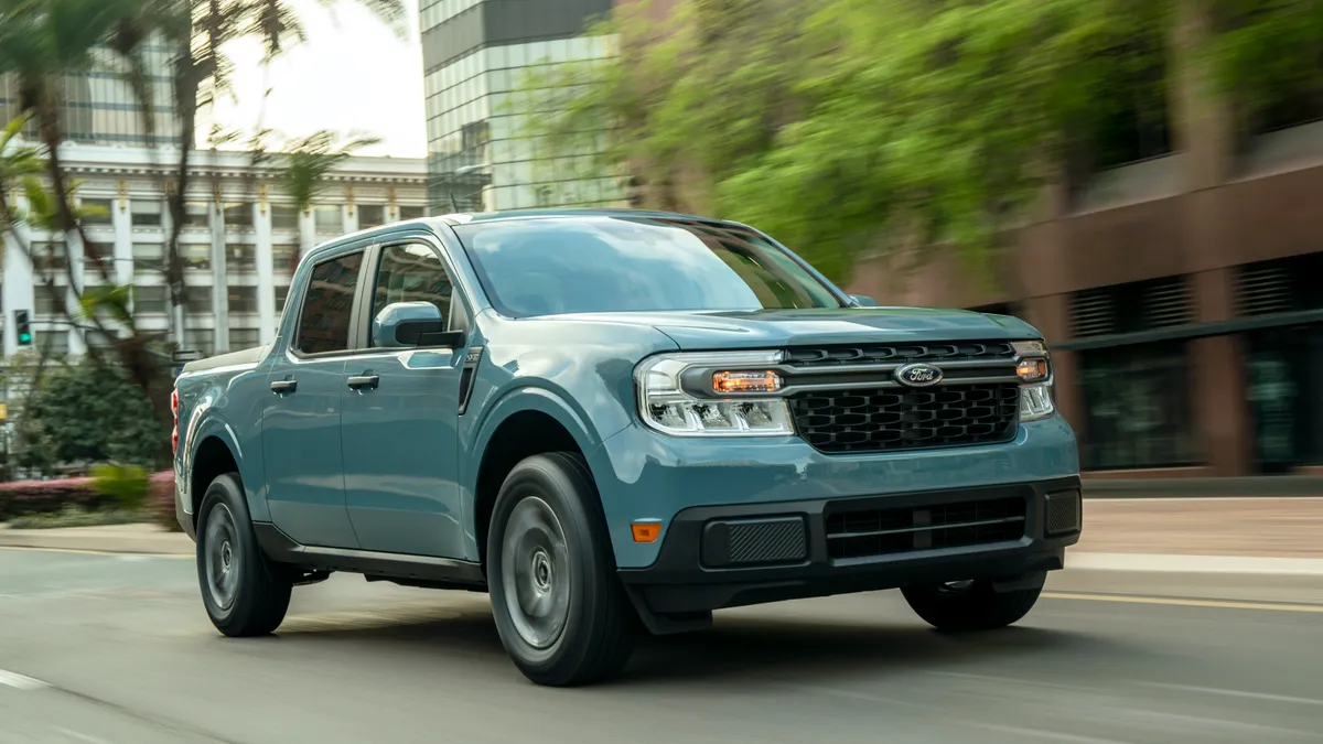 A 2022 Ford Maverick Hybrid XLT driving on an urban street.