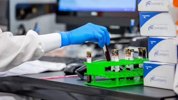 a lab worker with testubes of blood