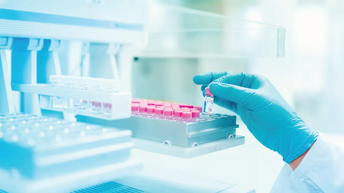 Close chemist scientist holding sample examining.