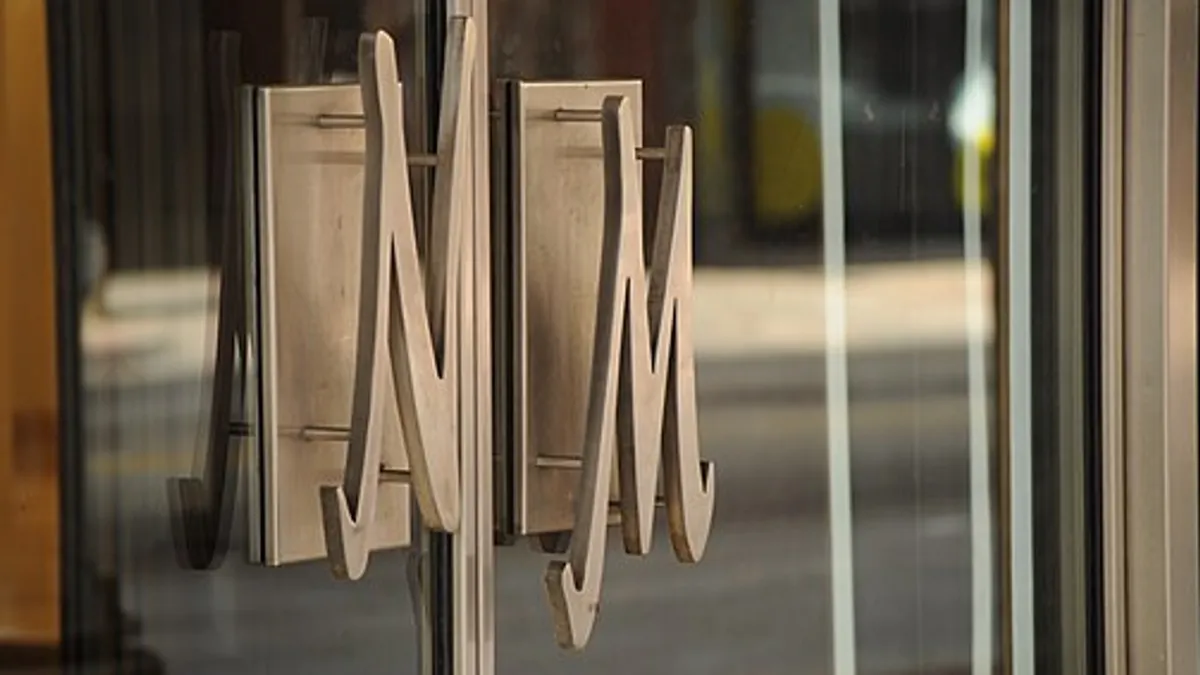 Closeup of door handles in the shape of the letters N and M