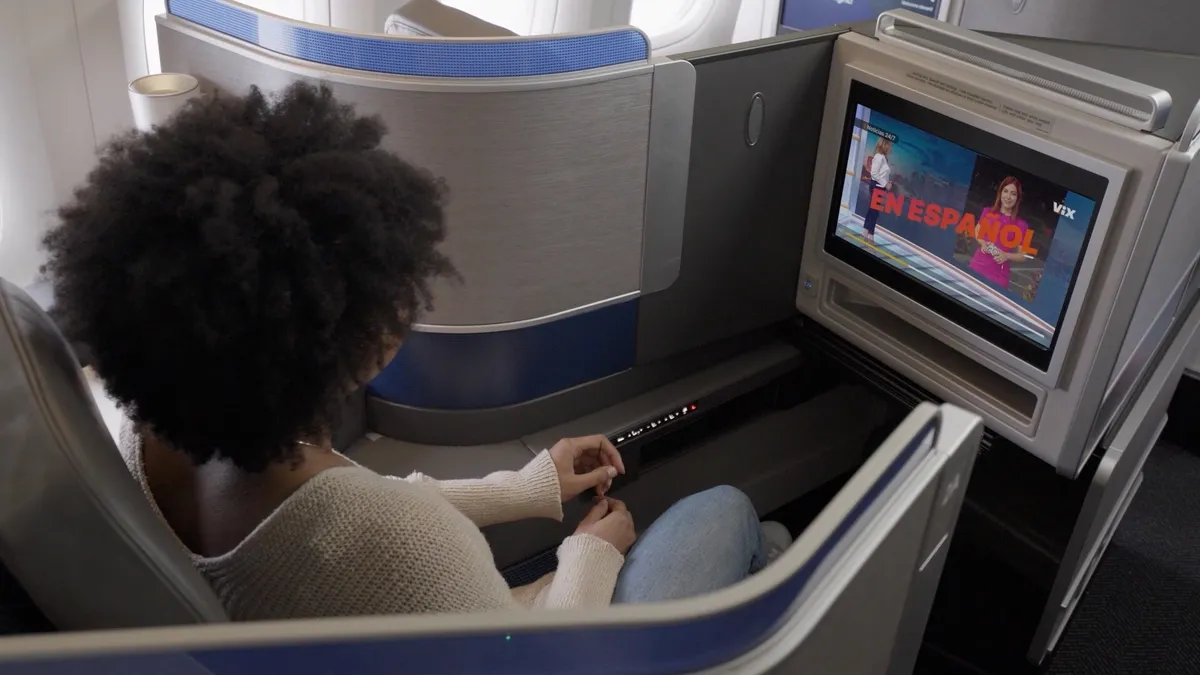 Person on United Airlines flight watching seatback screen