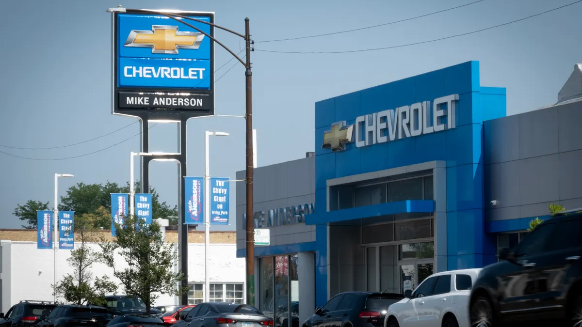 A sign at the entrance of a GM dealership on July 22, 2025 in Chicago, Illinois