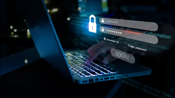 A hand typing login and password