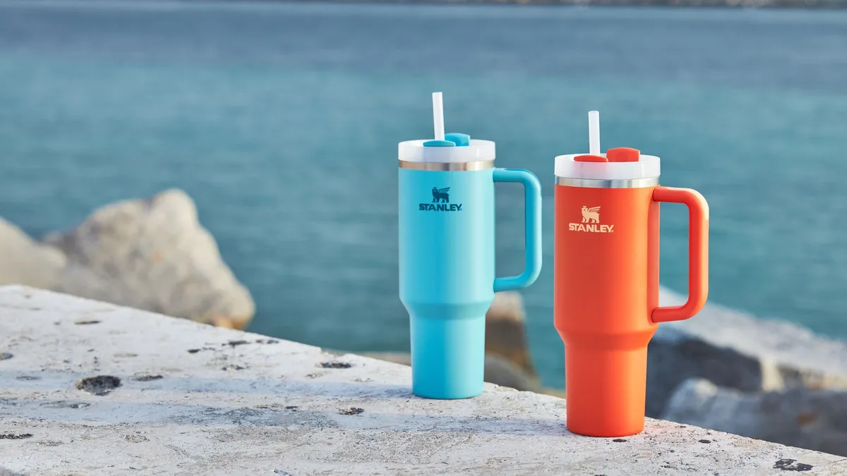 Two of Stanley's Quencher tumblers in blue and orange.