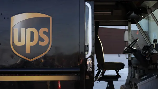 A UPS hybrid electric truck is seen outside a company facility.
