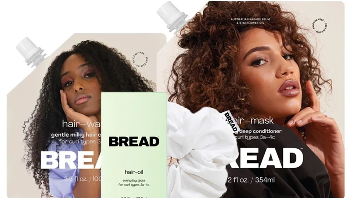 Two models with curly hair pose with Bread hair care products