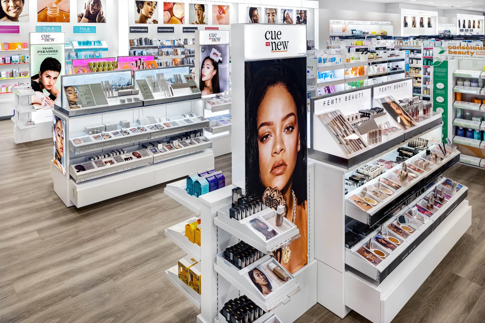 Orange and white Ulta store display saying "Cue the New"