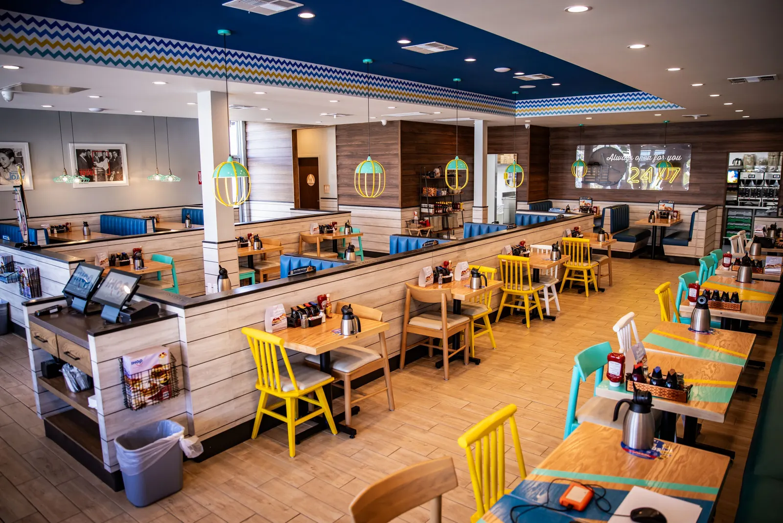 An interior image of an IHOP location with blue booths and yellow seats
