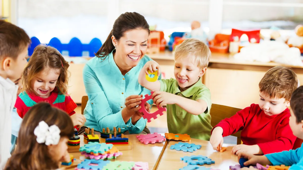 Nursery teacher playing with the kids