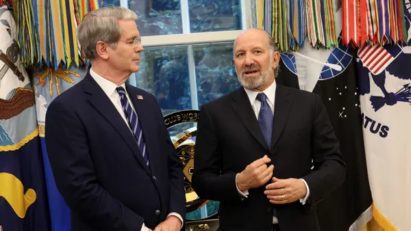 U.S. Commerce Secretary Howard Lutnick (right) speaks with U.S. Treasury Secretary Scott Bessent (left) in the Oval Office of the White House on Aug. 6, 2025, in Washington, D.C.