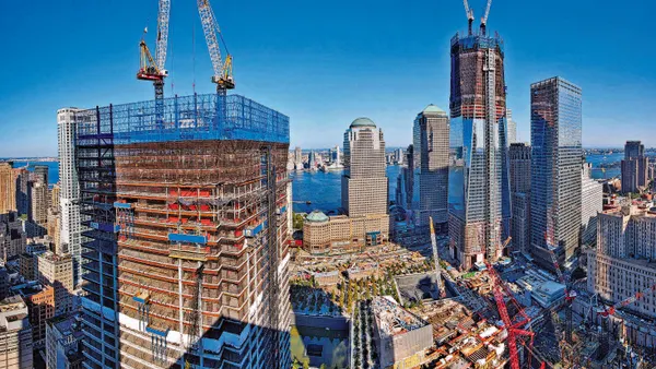 Several towers under construction in a major city.