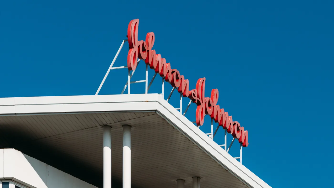 A sign spelling Johnson & Johnson stands above a building.