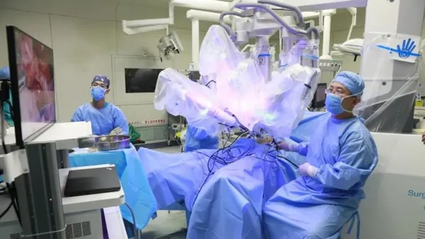 Members of a surgical team are shown in the operating room during a robot-assisted surgery in a hospital in Beijing.