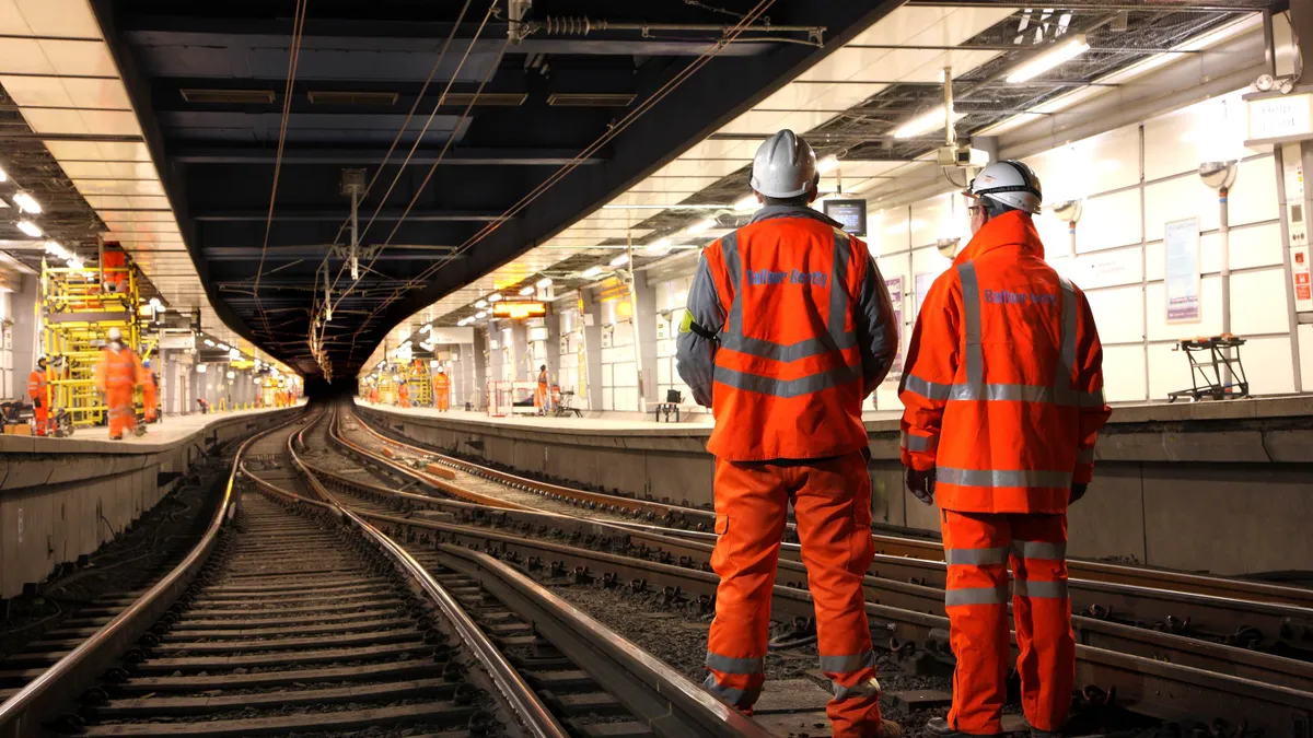 Two workers stand in the foreground on Balfour Beatty's Thameslink project.