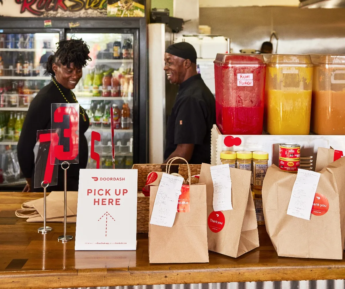 A counter top inside a restaurant with DoorDash orders