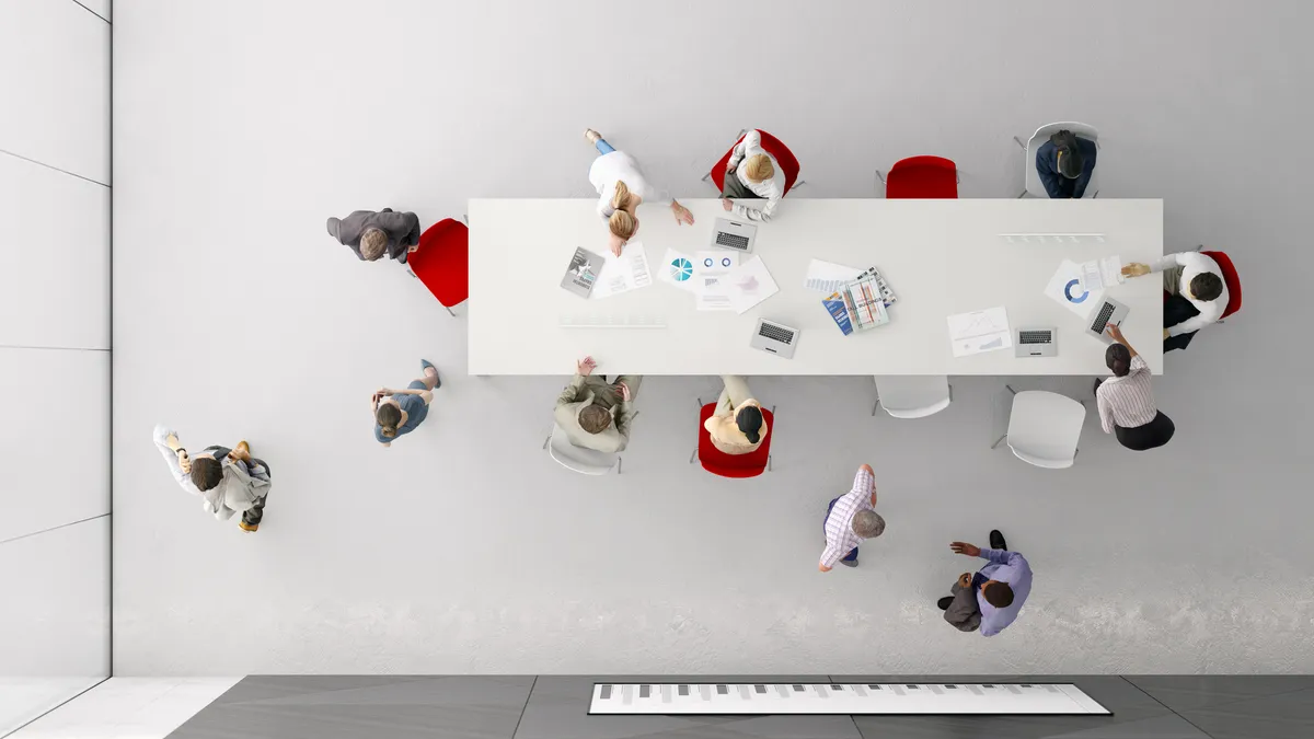 Overhead shot of people sitting around a corporate table