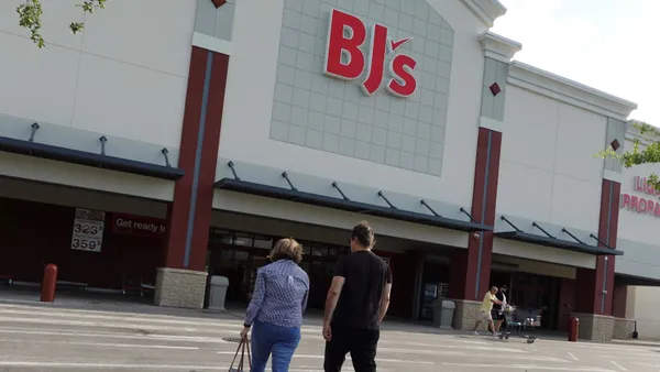 Two people walk into a BJ's Wholesale Club store.