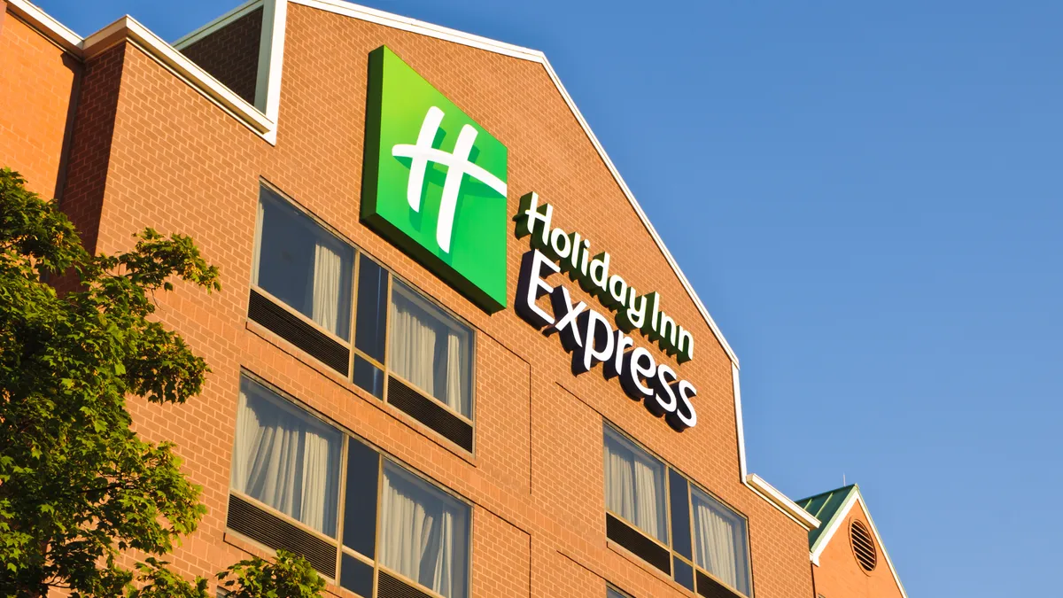 Holiday Inn Express hotel with logo on front facade and several guest room windows.