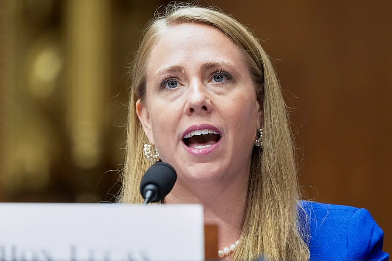 A person speaks at a podium with a microphone in front of them.