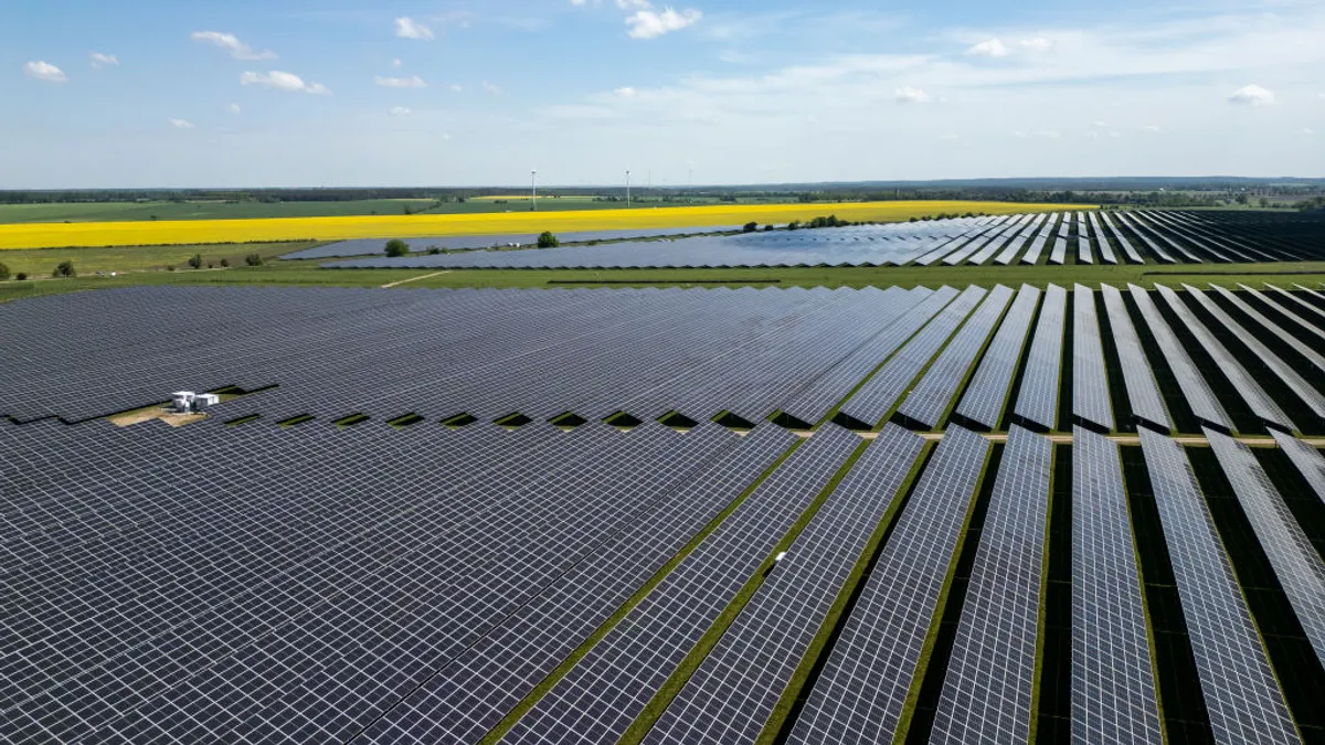 In this aerial view, solar panels point to the sky at the Weesow-Wilmersdorf solar park by energy supplier EnBW AG on May 03, 2024 near Grischow, Germany.