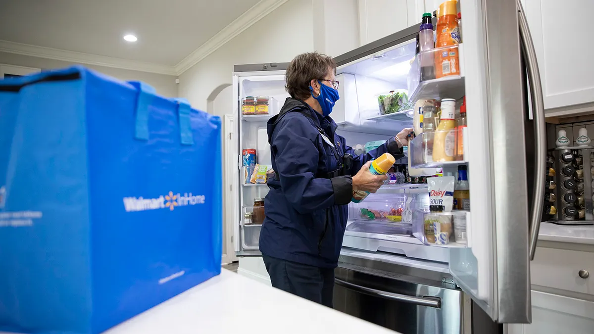 Grocery delivery worker in kitchen