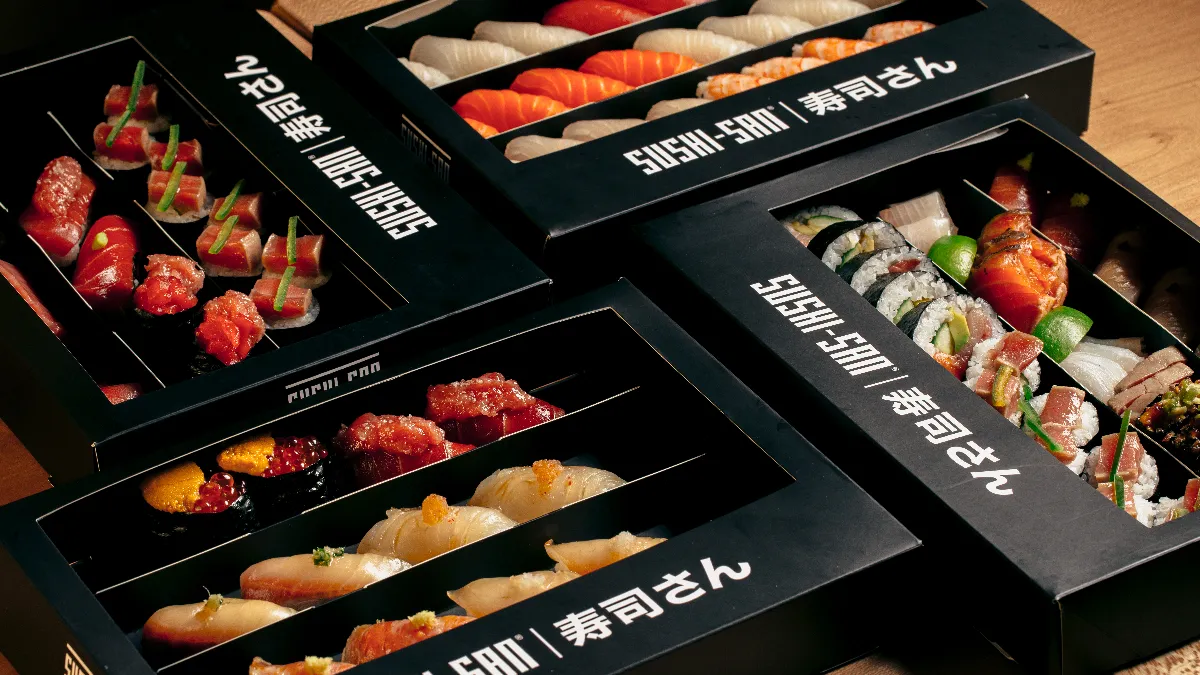 An image of black boxes that contain various sushi items