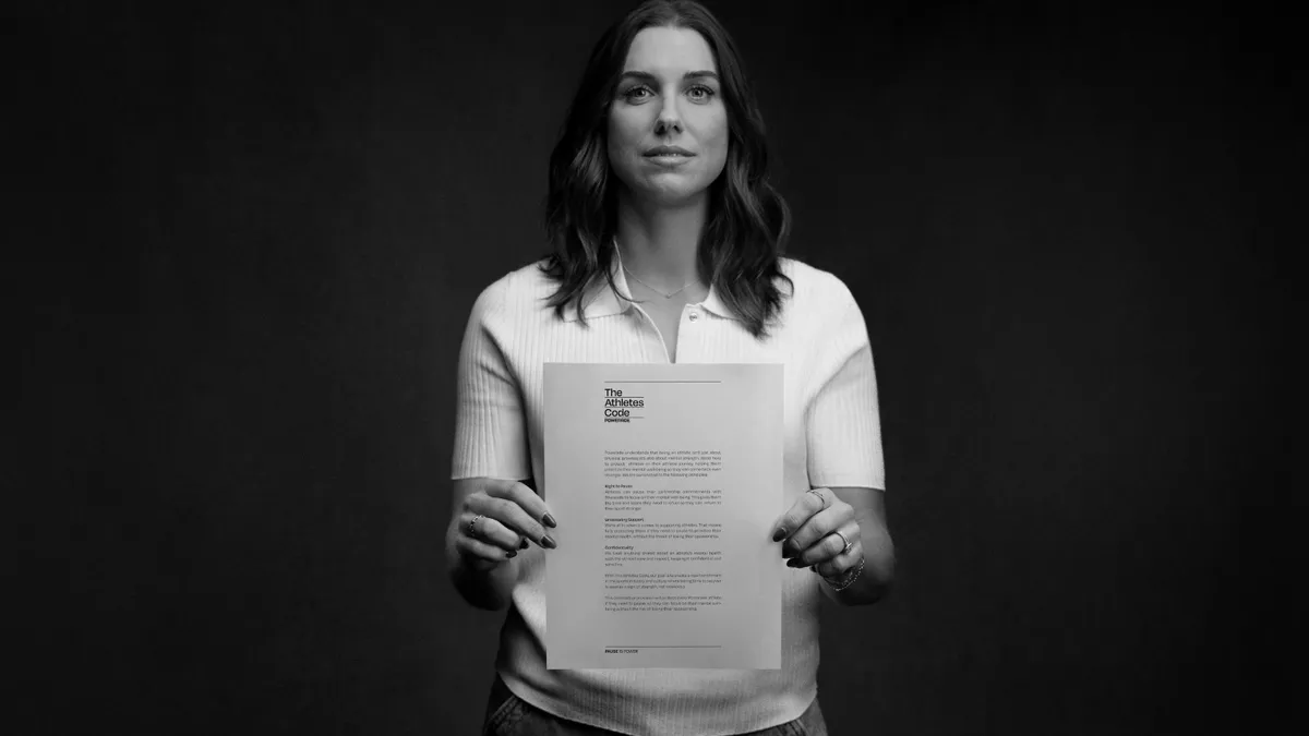 Alex Morgan holds The Athlete's Code for Powerade