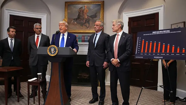 Donald Trump (C) speaks during a press conference in the Roosevelt Room of the White House with health agency leaders on either side
