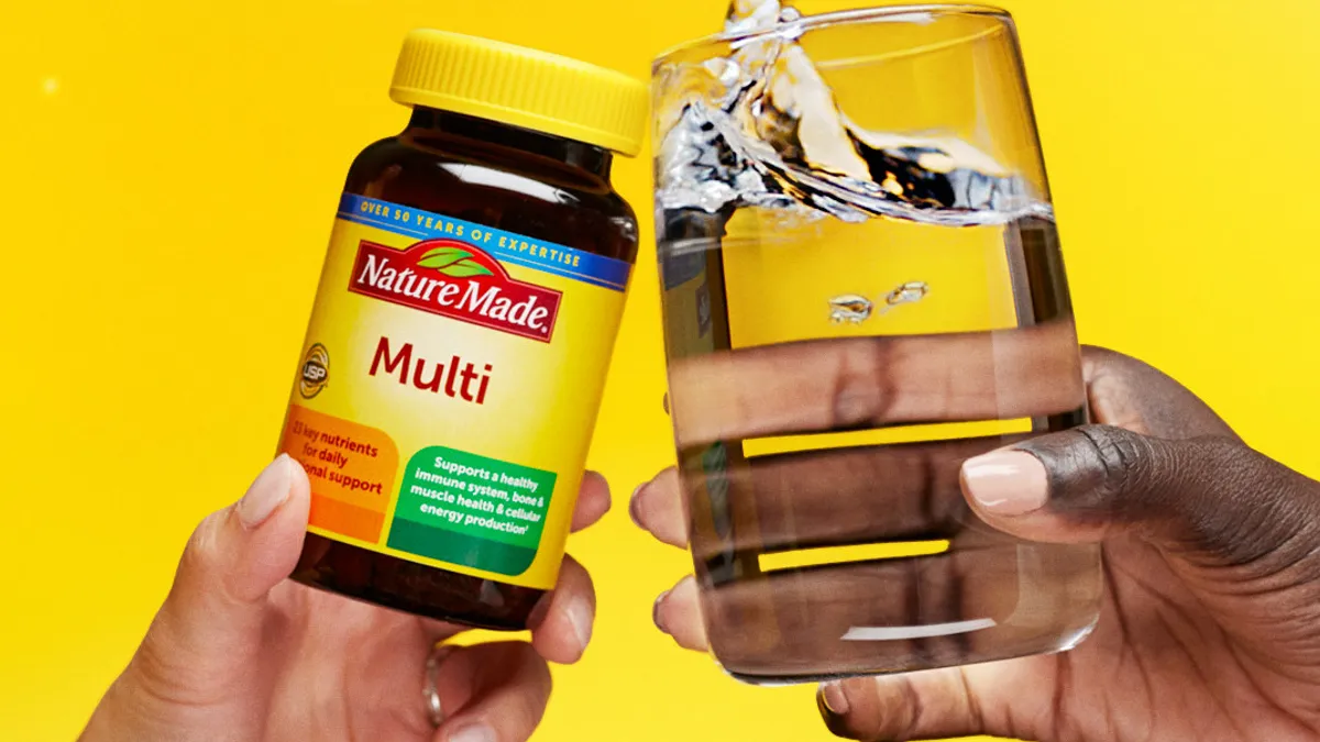 A bottle of Nature Made vitamins with text reading "Cheers to happy, healthy starts" as part of Nature Made's "The Start of Something Great" campaign.