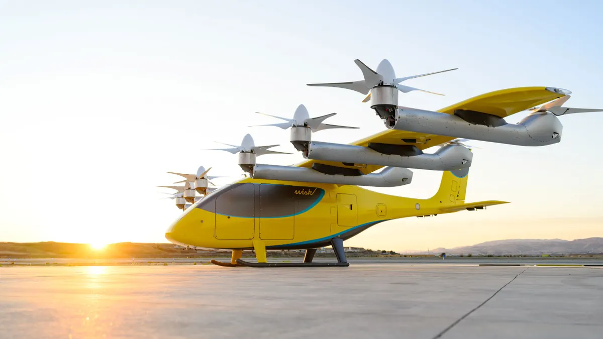 A small yellow aircraft with six propellers parked on an airport apron.