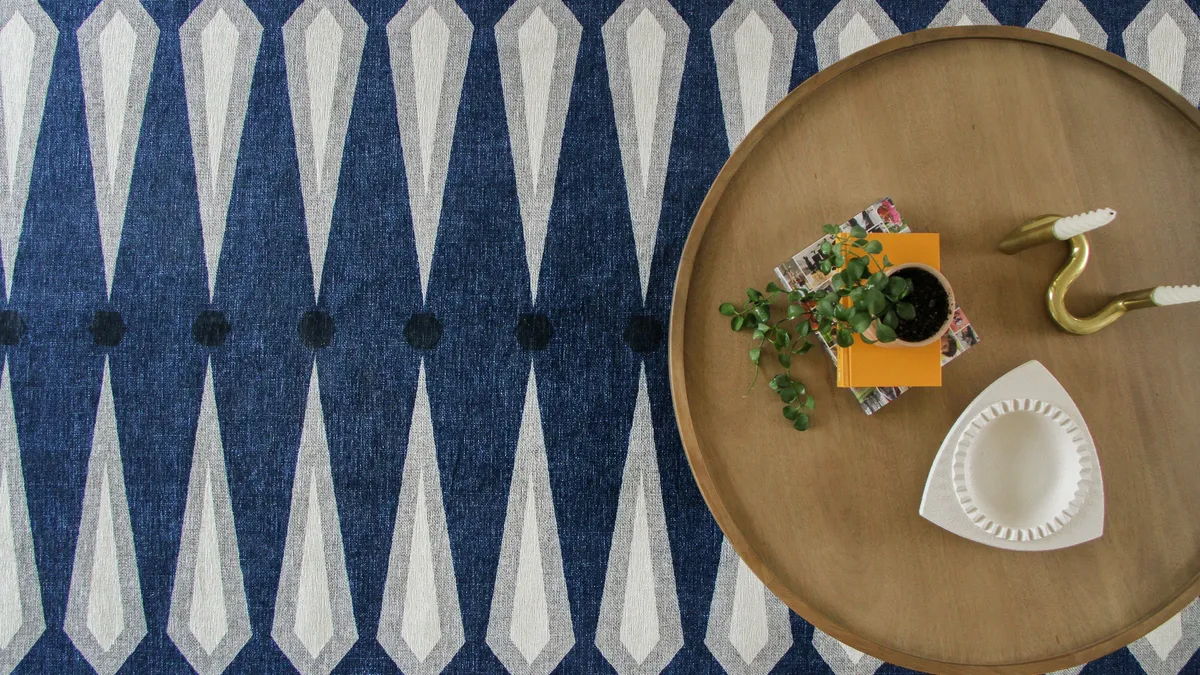 Blue and white striped pattern rug with a brown table on top