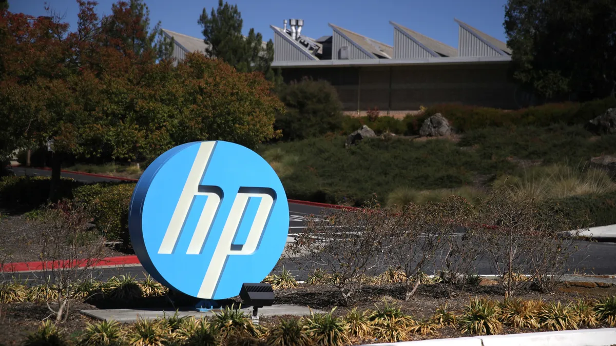 Hewlett Packard logo is displayed in front of office complex.