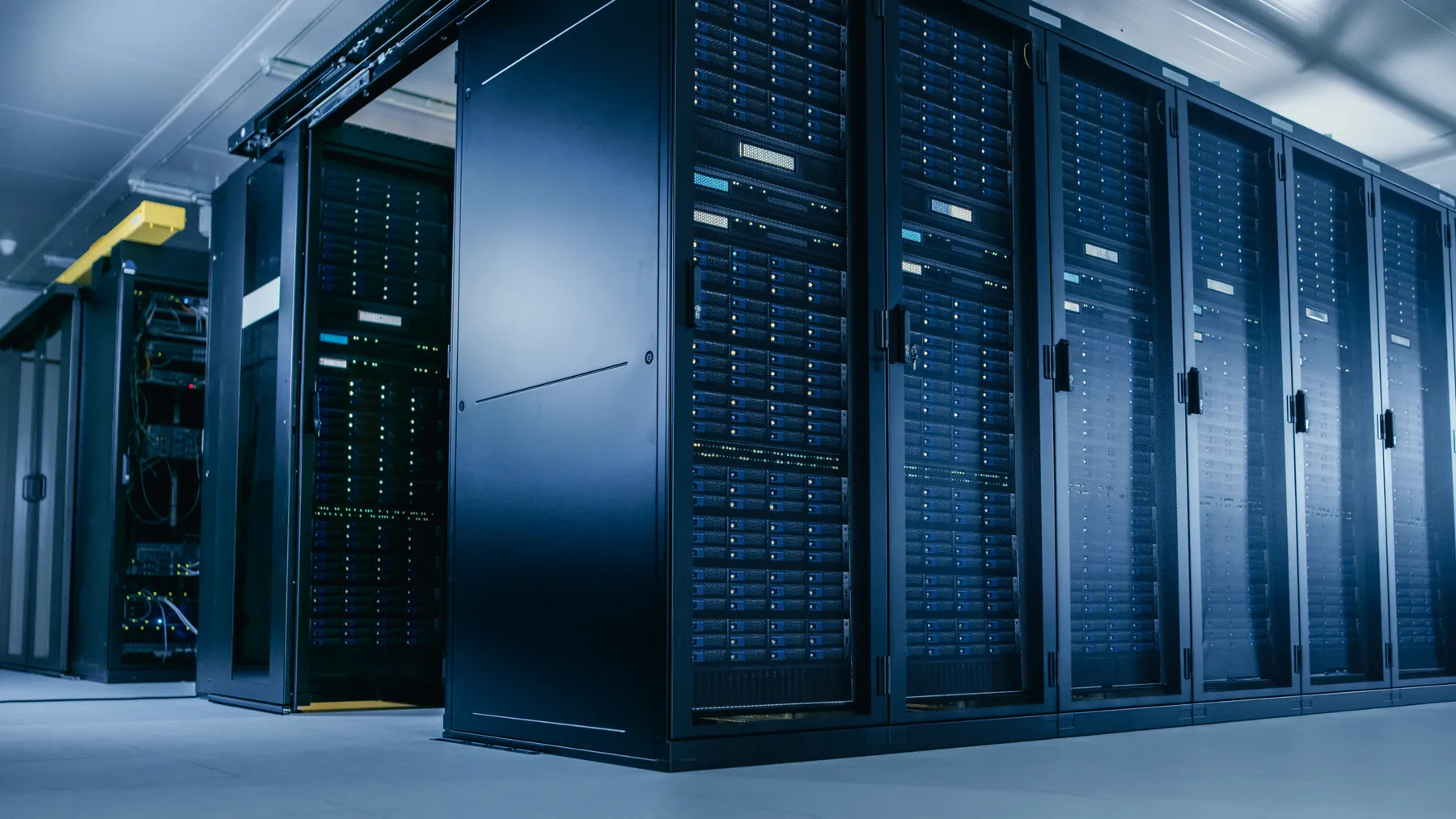 Low Angle Shot of Data Center With Multiple Rows of Fully Operational Server Racks.